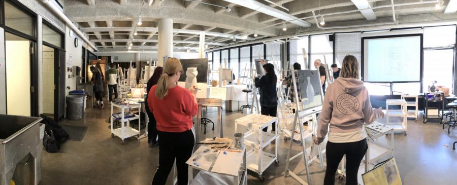 Panoramic image of students painting in class at Century College