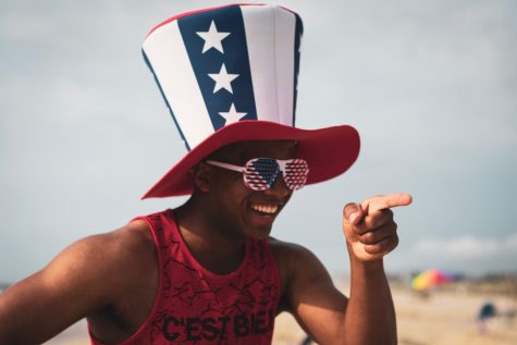 Person on the beach wearing an American flag hat.