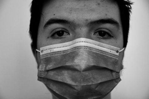 Grayscale photo of person wearing mask