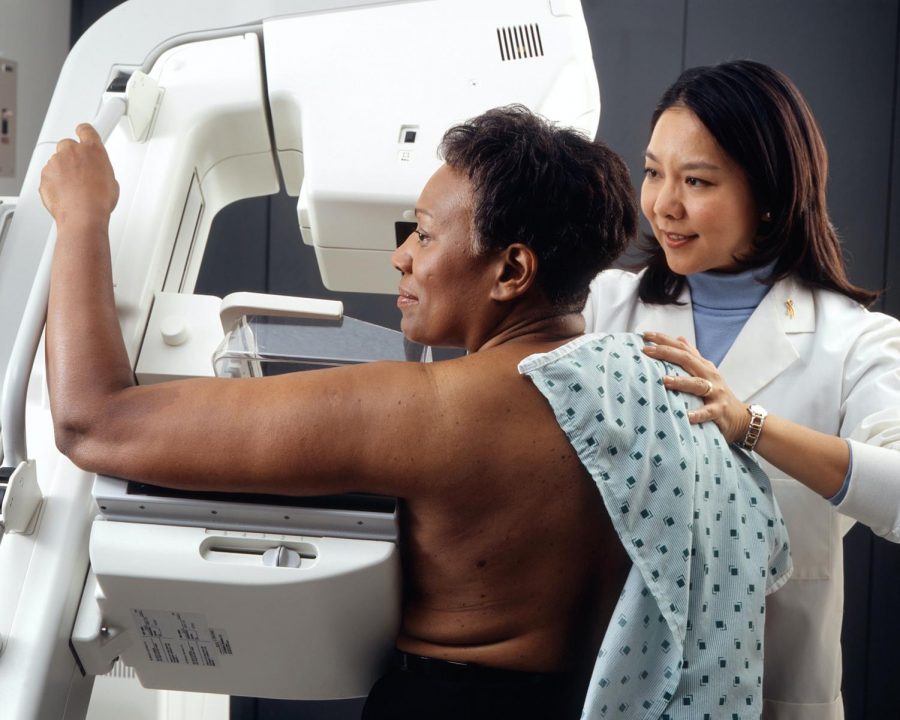 African American woman is screened for breast cancer.
