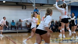 The Century College Women's Volleyball team in action during a match earlier in the season.