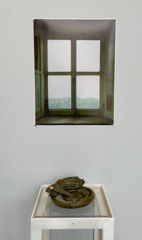 Monika Rogge’s two-part piece, Window and Relics, is a work of digitally manipulated photography and hand built ceramic pieces.