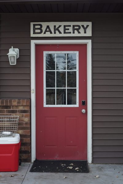 A red door with the words "Bakery" above it.